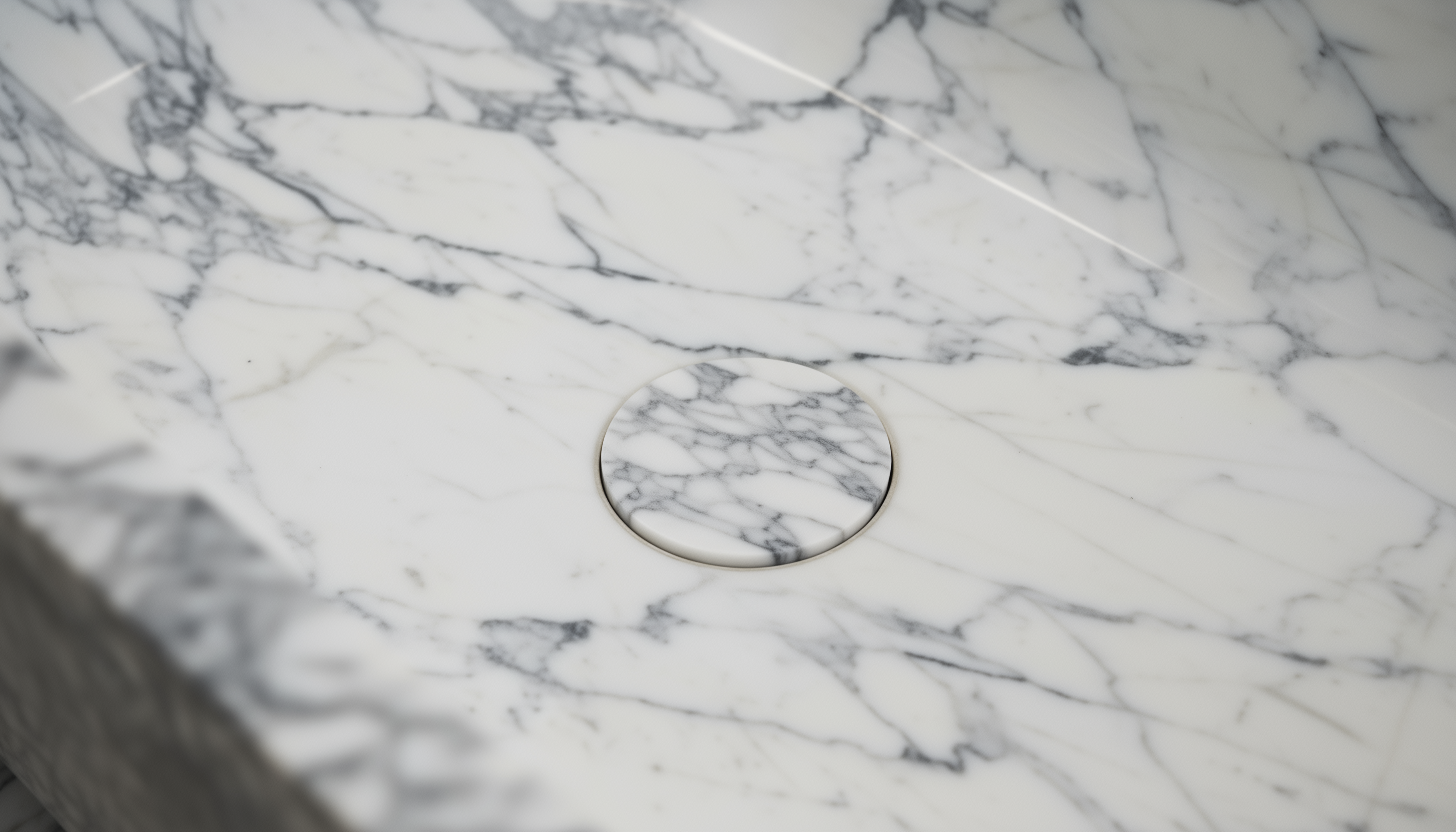 Marble countertop with a circular drain cover