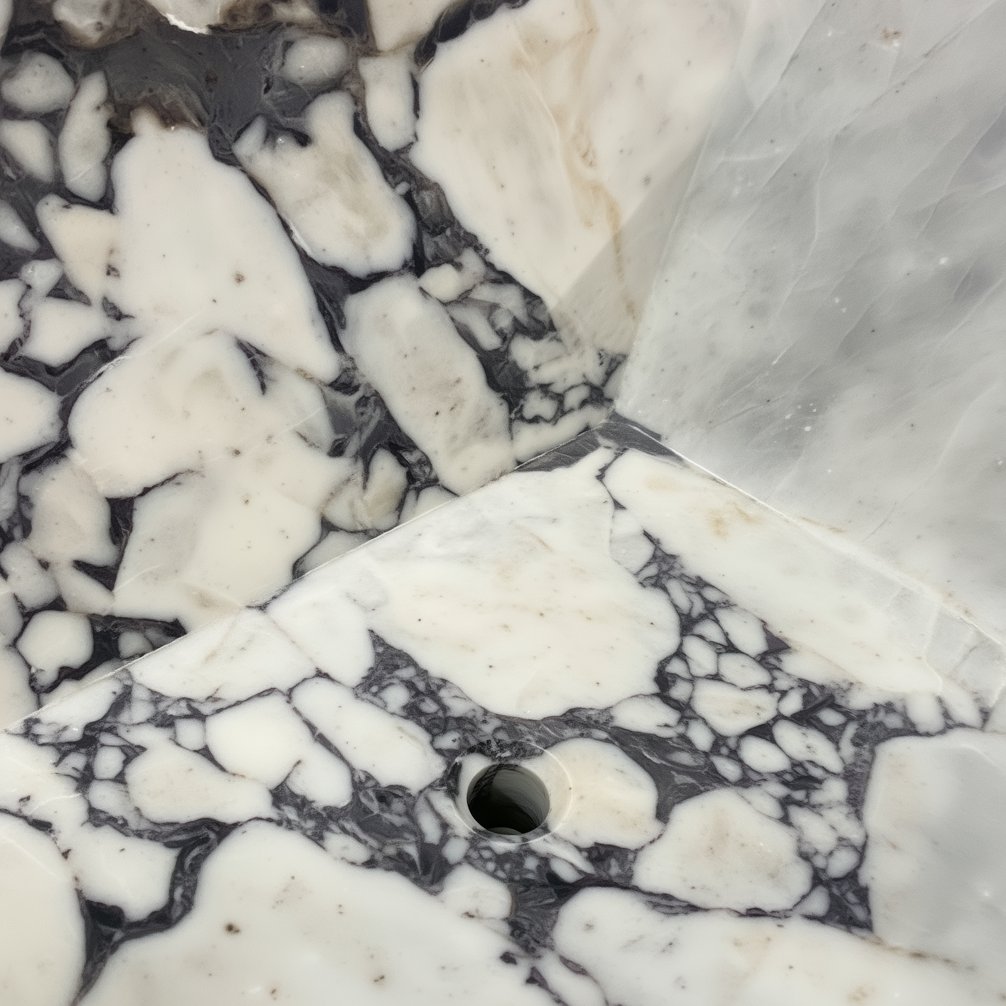 Close-up of a marble surface with white, gray, and black patterns.