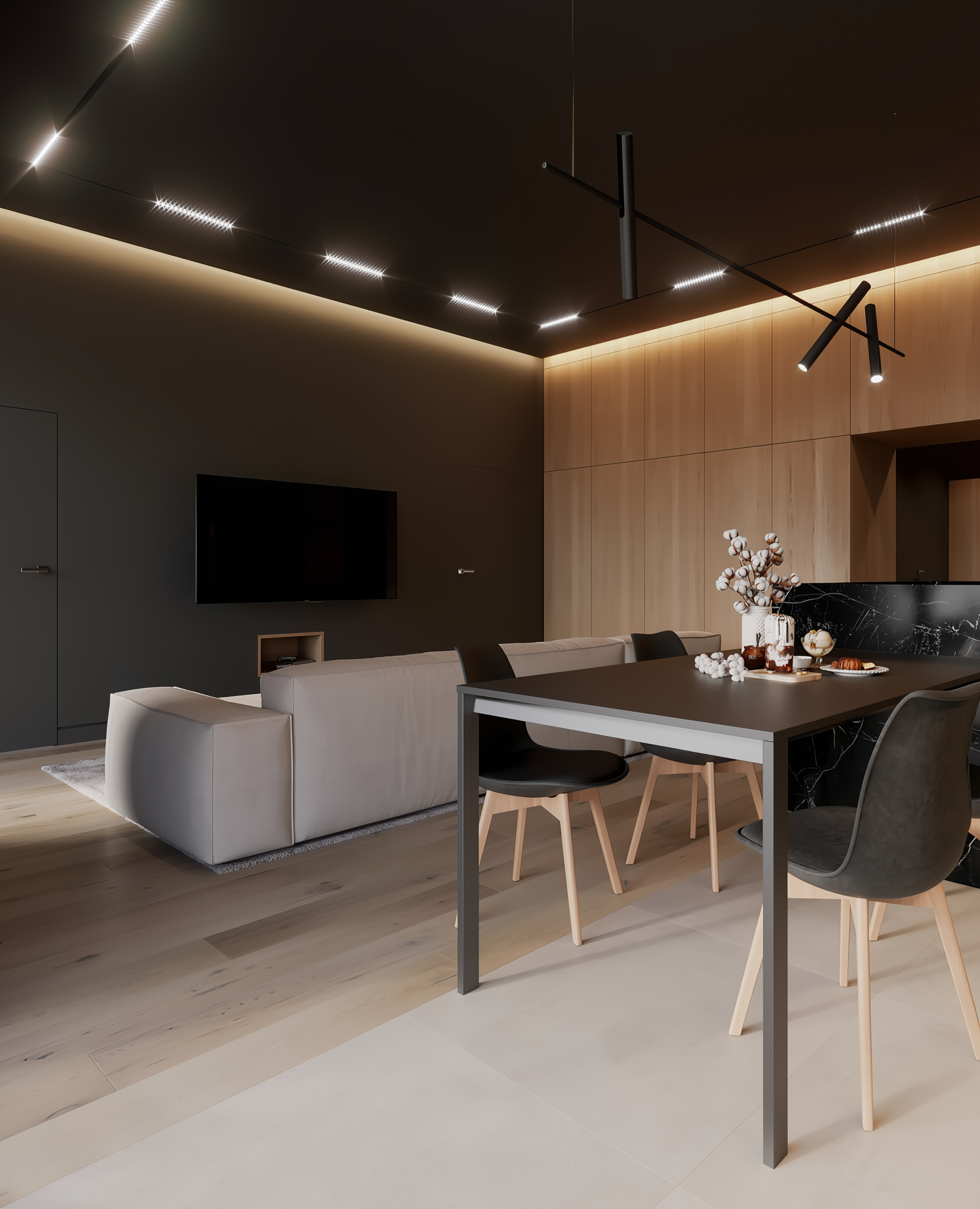 Modern living room with gray sofa, dining table, and black ceiling lights.