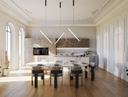 Modern kitchen with a dining table and chairs in a well-lit room.