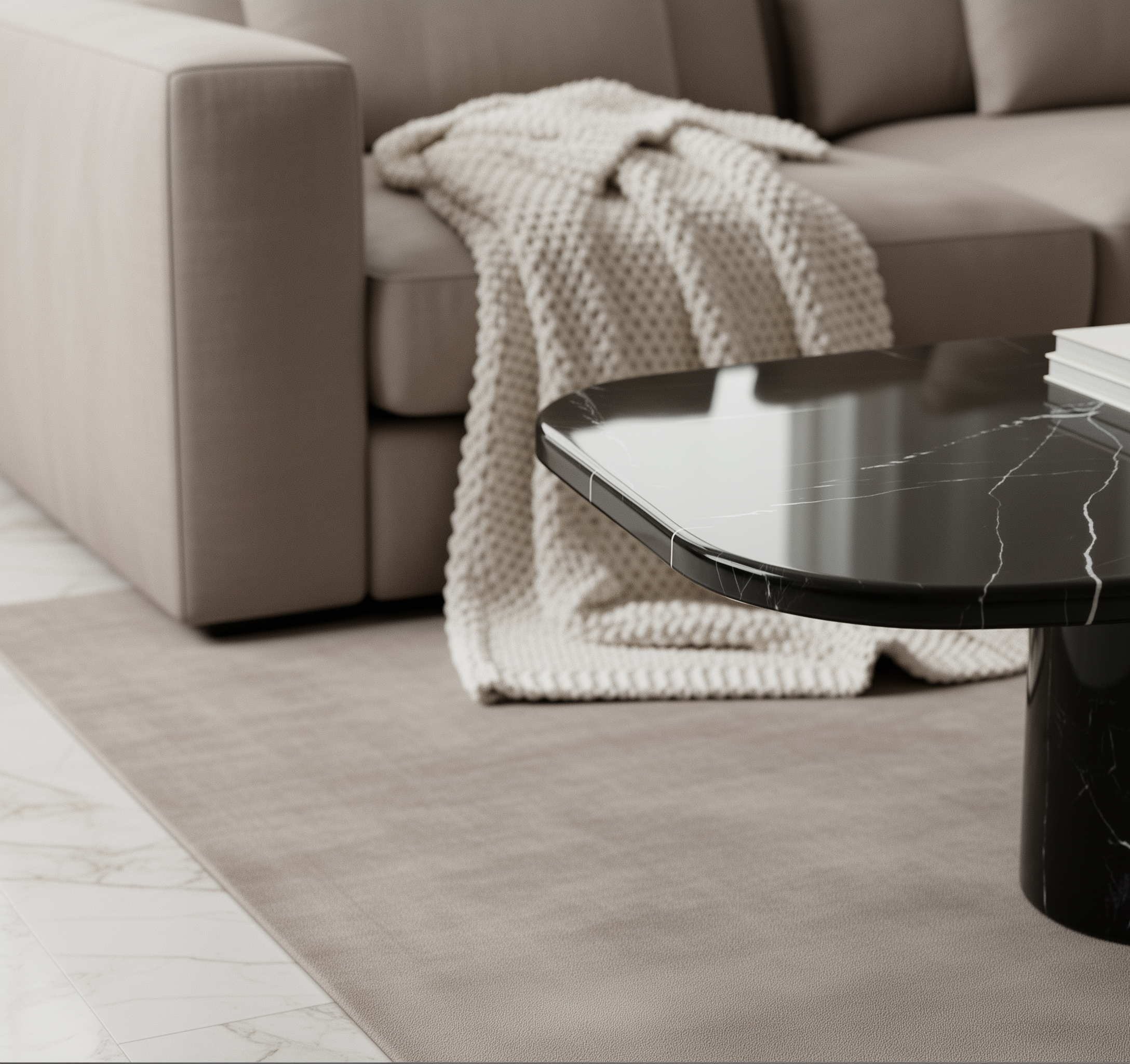 Round marble table in a living room with a beige sofa and blanket.