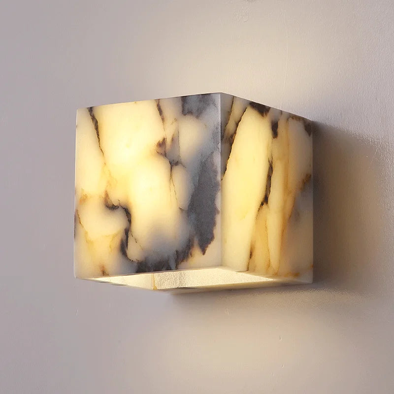 Marble-patterned wall light fixture on a plain wall