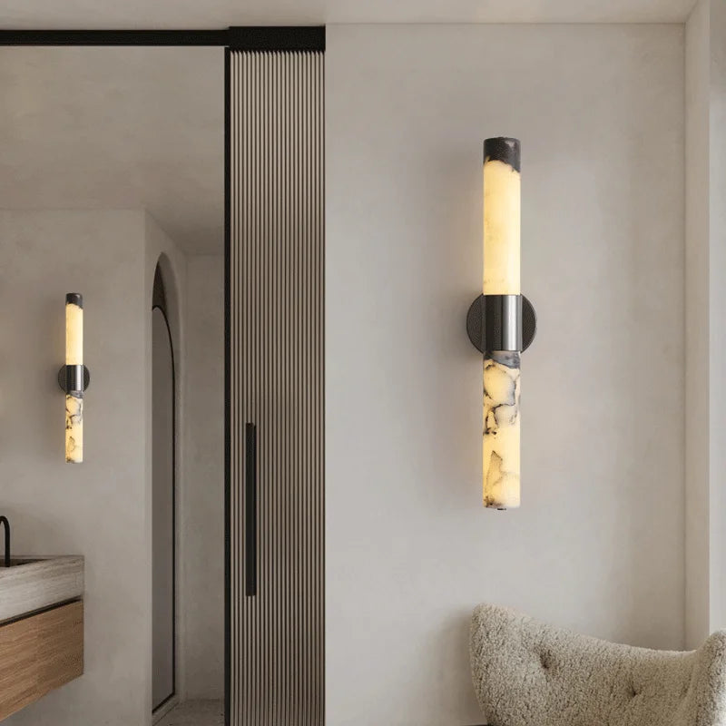Modern wall sconces in a bathroom setting with neutral tones.