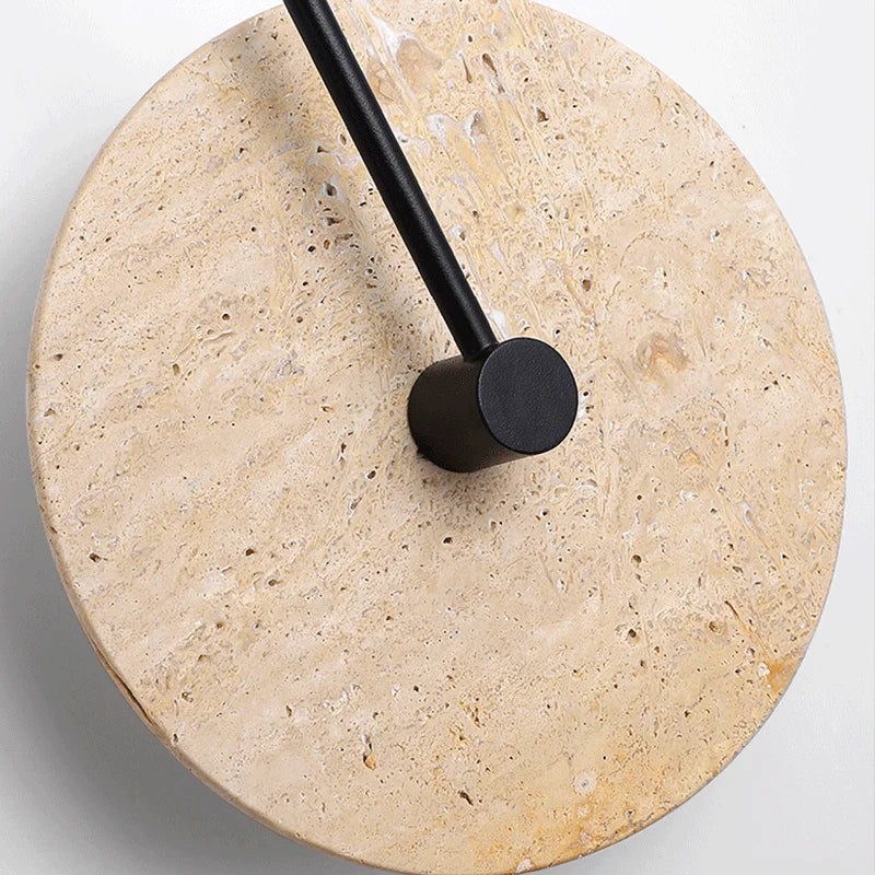 Round stone surface with a black cylindrical object on top