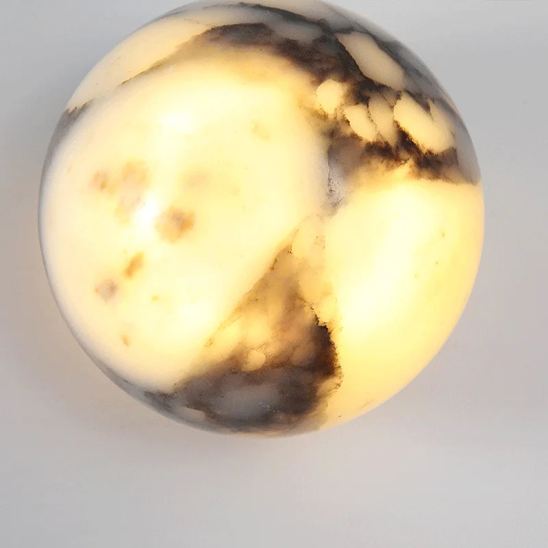 Marbled stone object on a light gray background