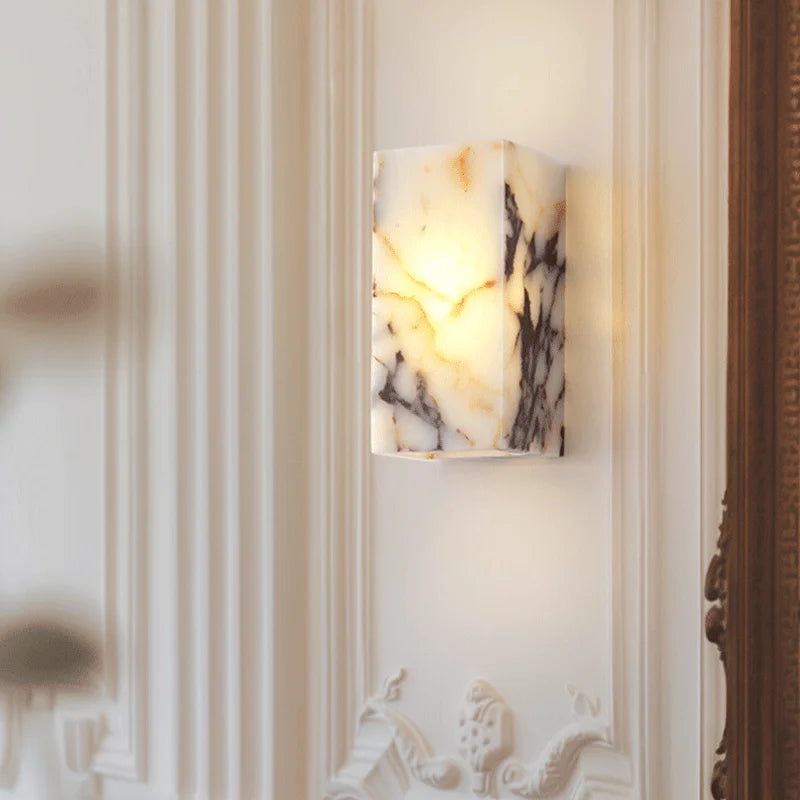 Marble-patterned wall sconce on a decorative wall
