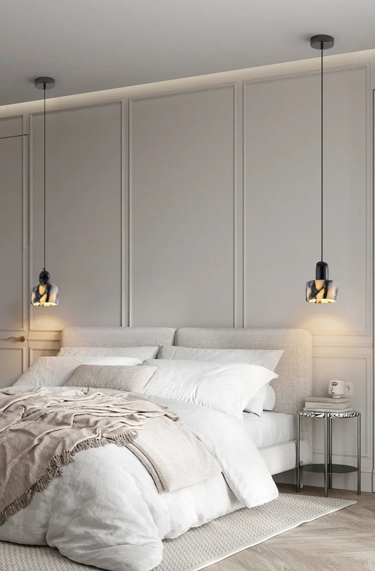 Modern bedroom with a bed, nightstands, and pendant lights.