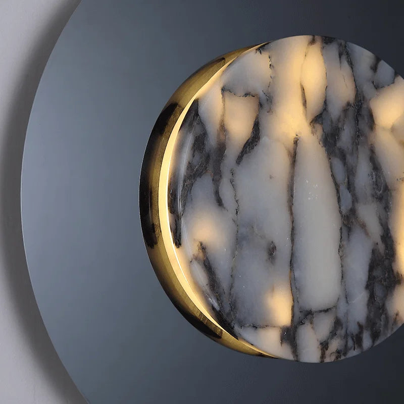 Round marble object with gold edge on a gray background