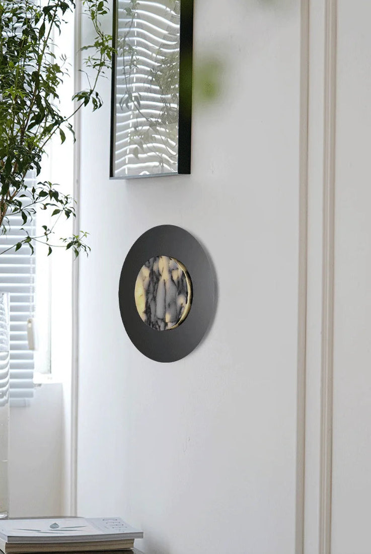 Decorative wall mirror with abstract design on a white wall
