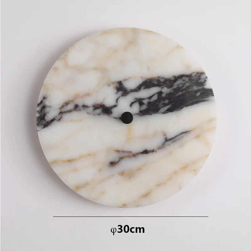Round marble coaster with a black center on a white background