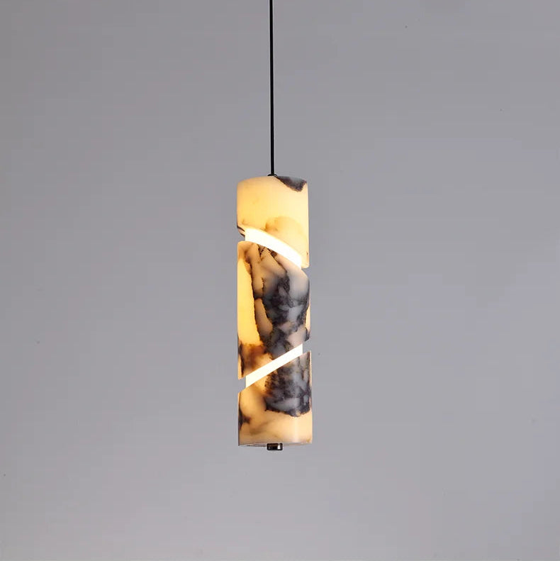 Pendant light with a cylindrical glass shade on a gray background