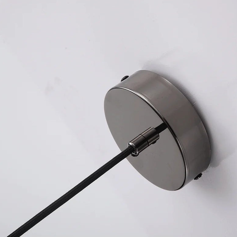 Modern pendant light with a white glass shade on a white background