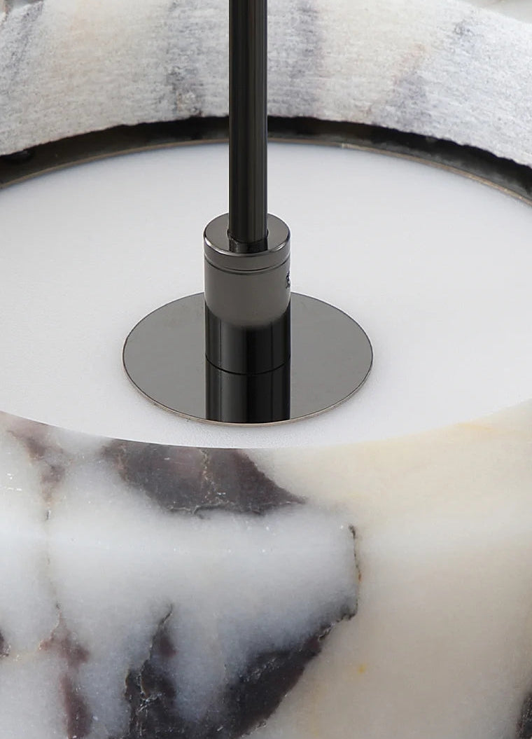 Close-up of a marble-patterned lamp with a black and silver base.
