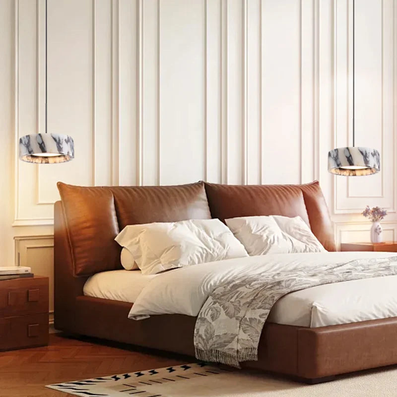 Brown leather bed with white bedding in a bedroom setting