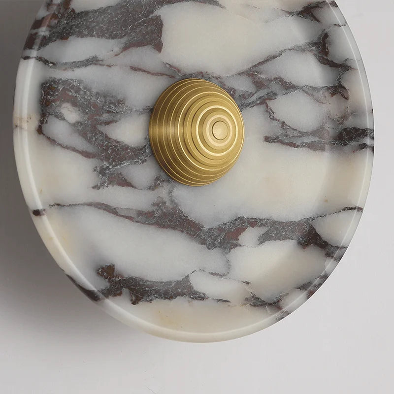 Marble-patterned coaster with a gold circular design on a white background