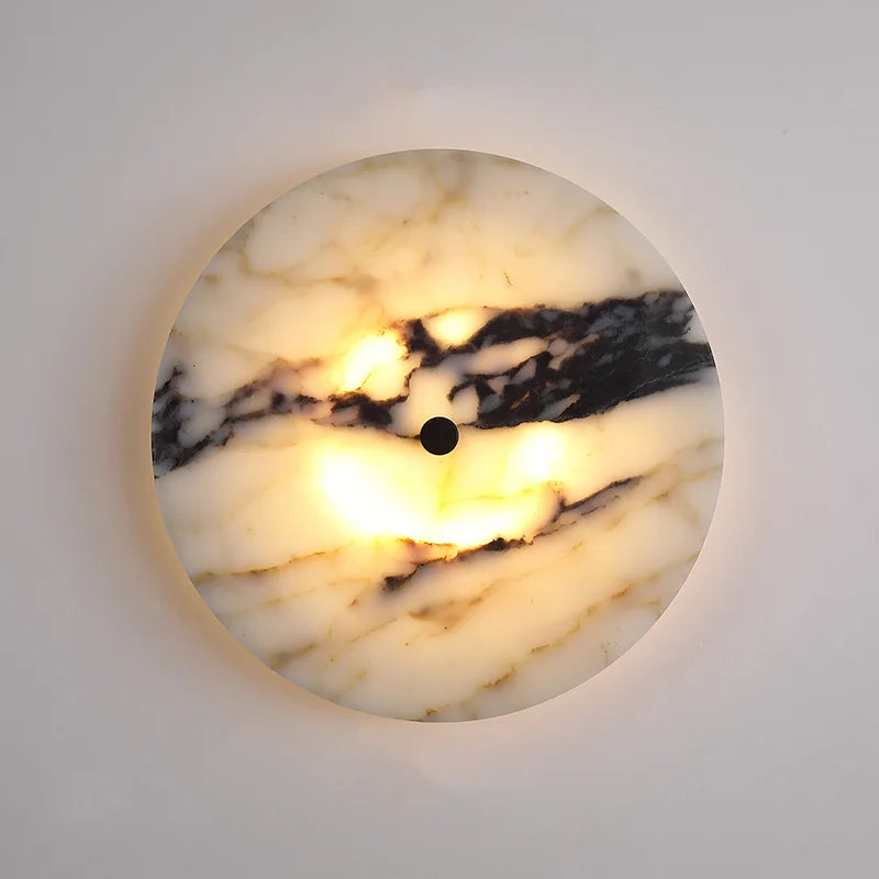 Round marble-patterned light fixture on a white wall