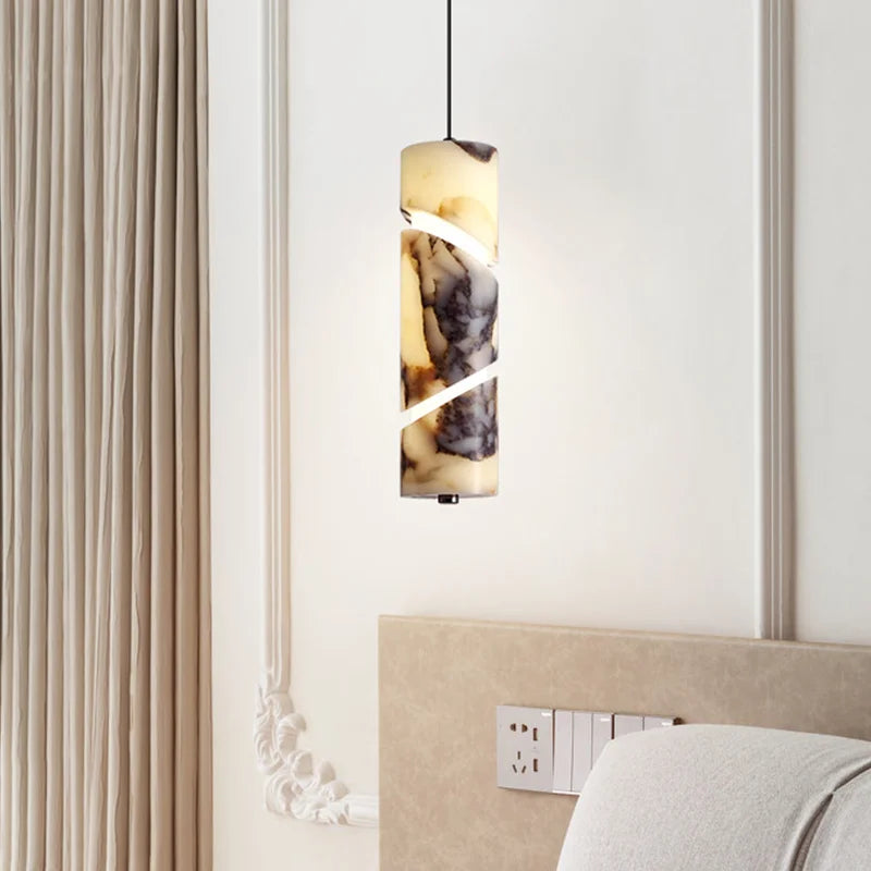 Decorative pendant light fixture on a wall with a neutral color scheme.