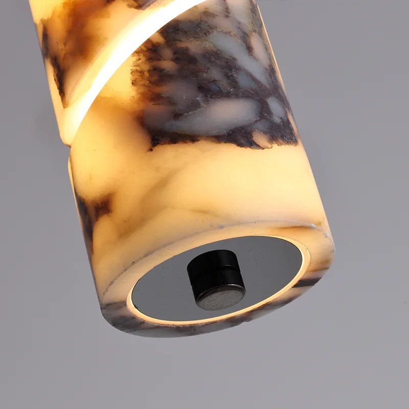 Marble-textured cylindrical light fixture on a gray background