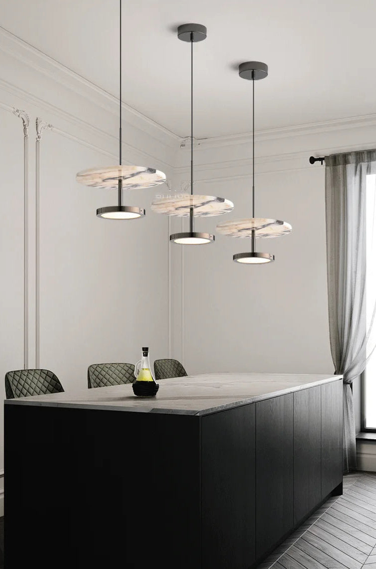 Modern kitchen island with pendant lights in a bright room