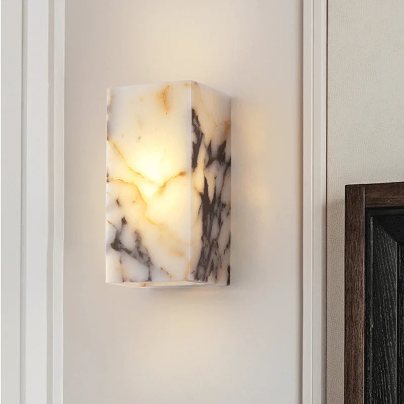 Marble-patterned wall sconce on a neutral wall