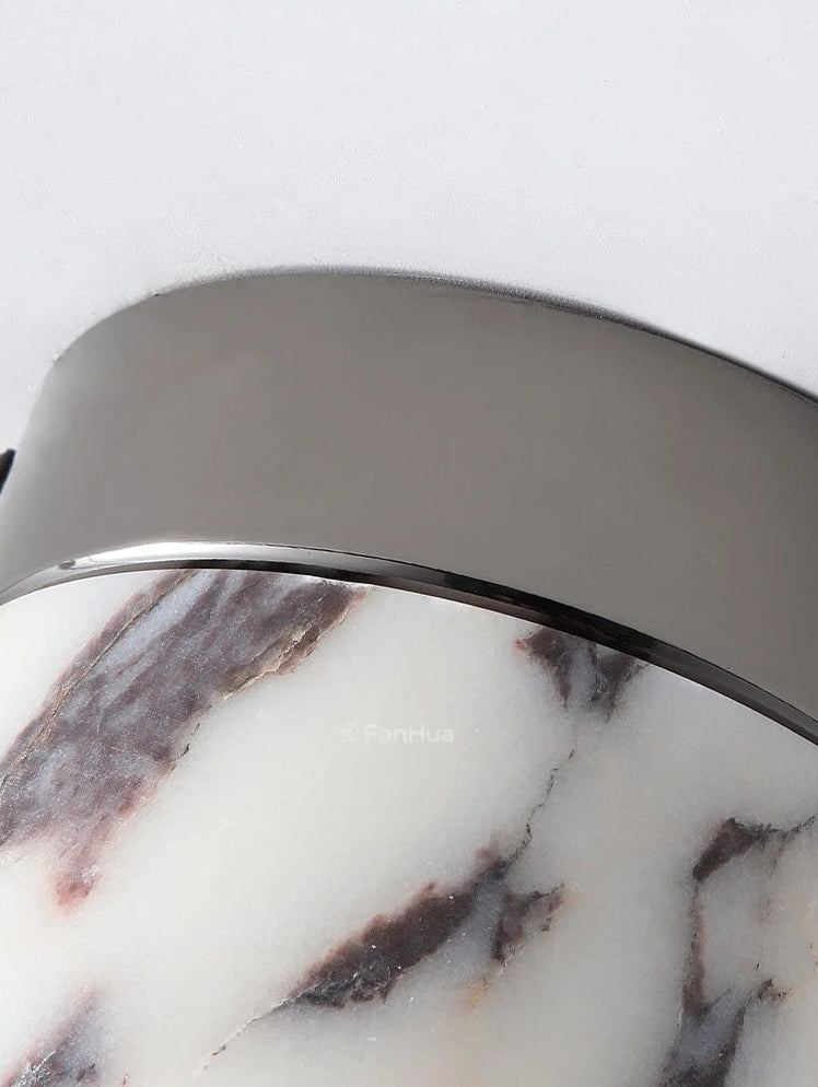 Close-up of a product with a marble pattern and metallic rim on a white background