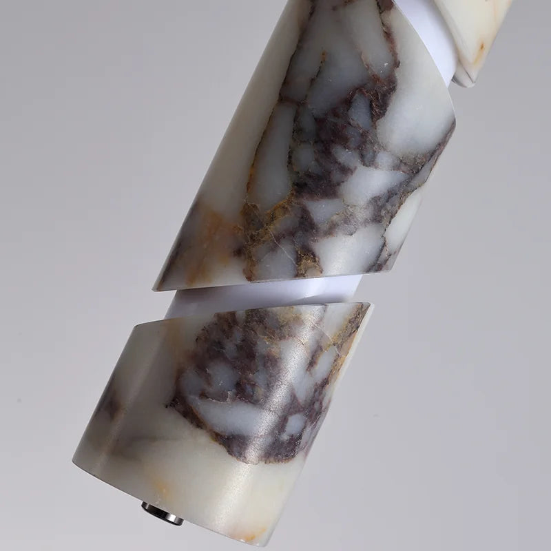 Marble-patterned cylindrical object on a light gray background