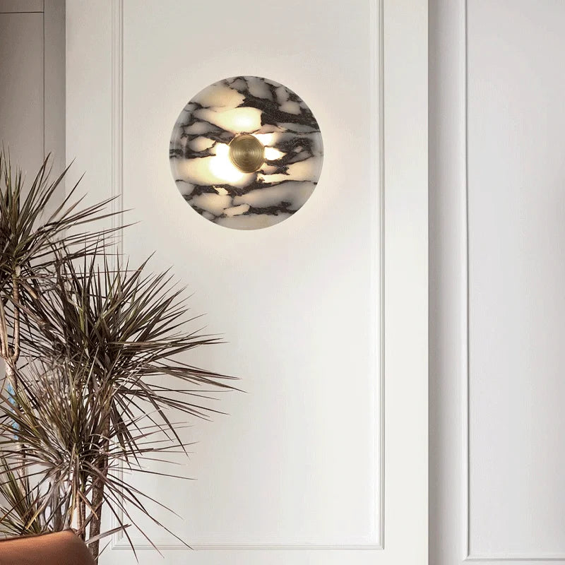 Round wall light fixture with marble pattern on a white wall
