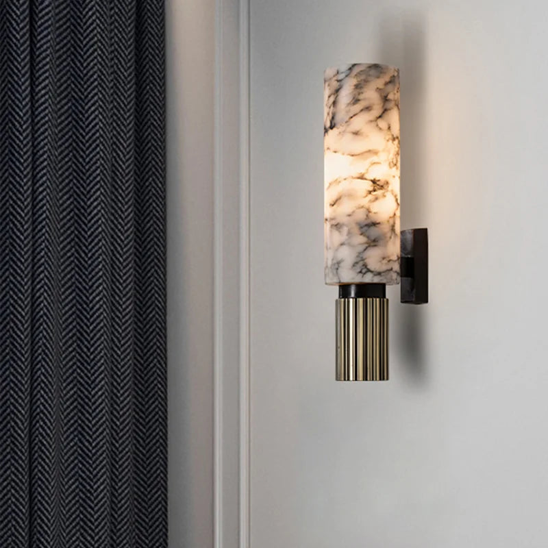 Wall-mounted light fixture with marble-like design on a gray wall.