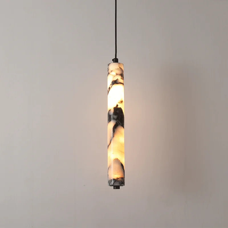Pendant light with marble-like design on a plain background