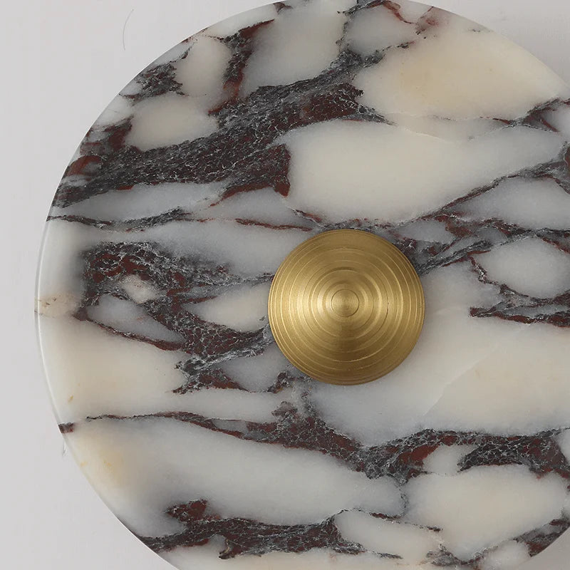 Marble coaster with a gold circular object on a white background