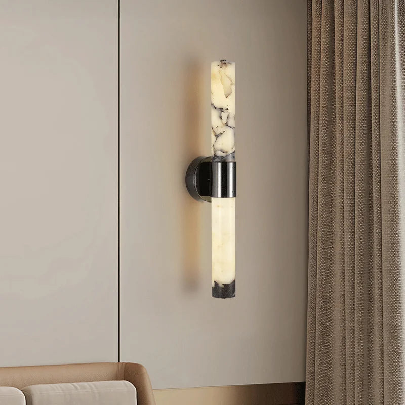 Modern wall sconce with marble-like design on a neutral wall.
