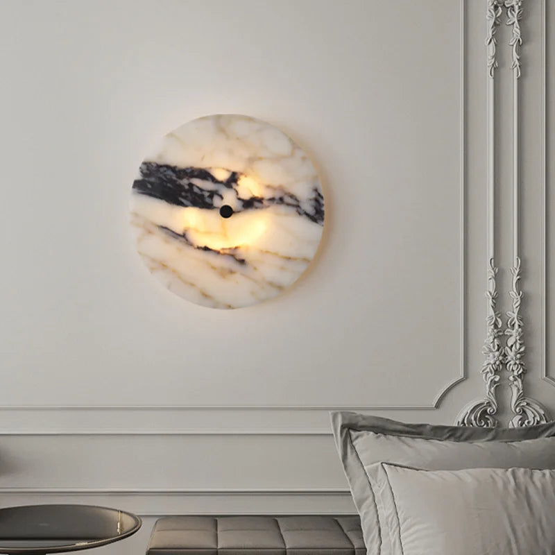 Marble-patterned wall sconce on a white wall with decorative molding.