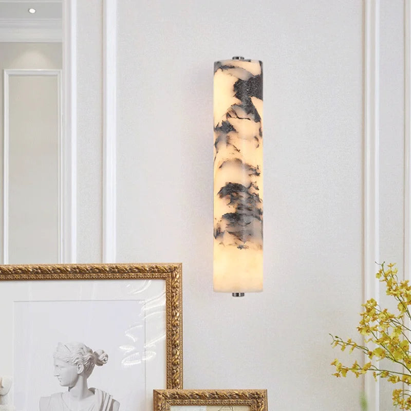 Decorative wall sconce with marble-like pattern on a white wall.