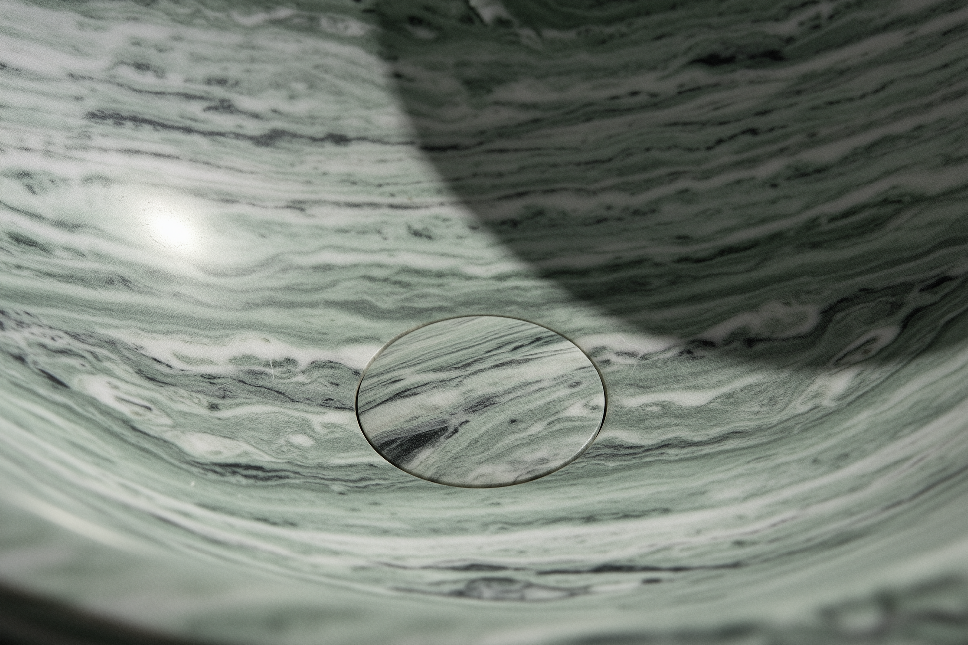 Round glass object on a marble surface