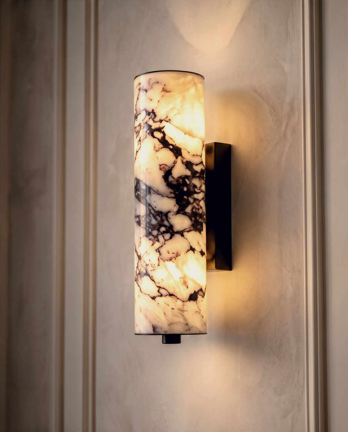 Siena marble wall light in Calacatta Viola stone glowing warm against a panelled plaster wall